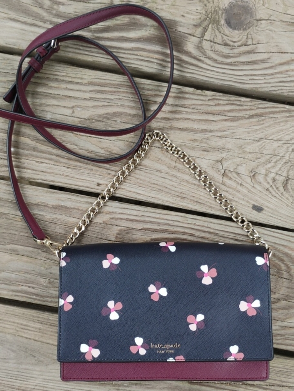 kate spade navy floral crossbody with burgundy strap and gold chain.  Like New